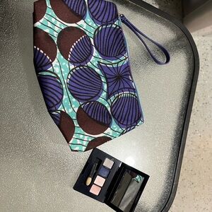 Estee Lauder blue and purple makeup bag with zipper pocket and magnetic makeup